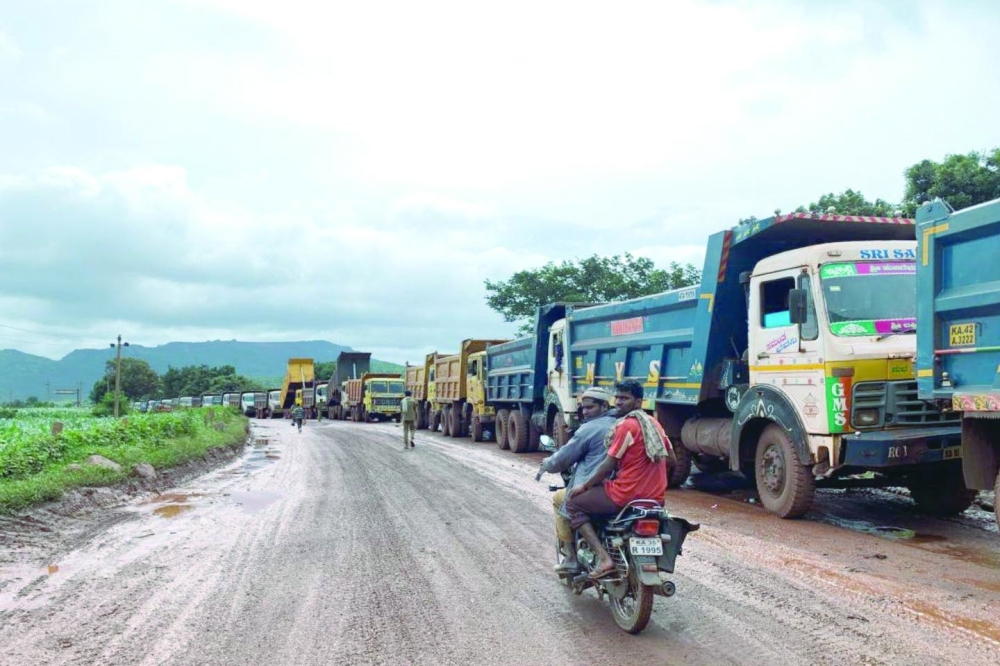 Trucks transporting for iron ore mines parked along the Sandur bypass in southern state of Karnataka, India. - Reuters