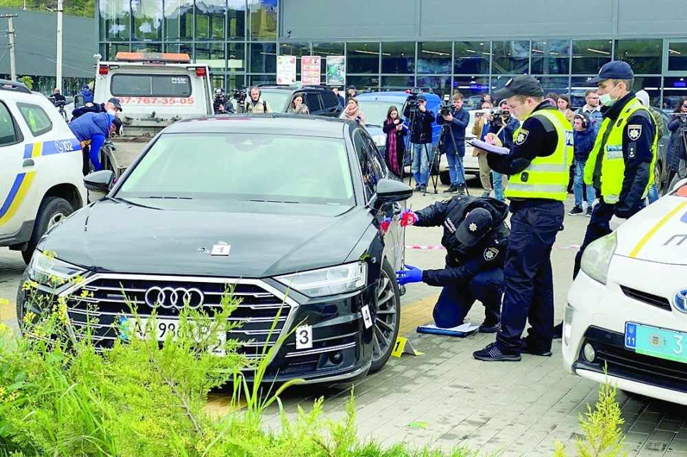 Investigators examine bullet holes in a car of Serhiy Shefir, Ukrainian President Volodymyr Zelenskiy's principal aide, following an assault outside capital Kyiv. - Reuters