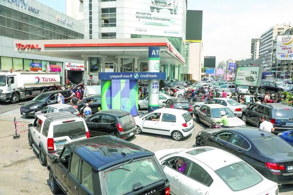 People wait in cars to get fuel at a gas station in Zalka, Lebanon, on Monday. - Reuters