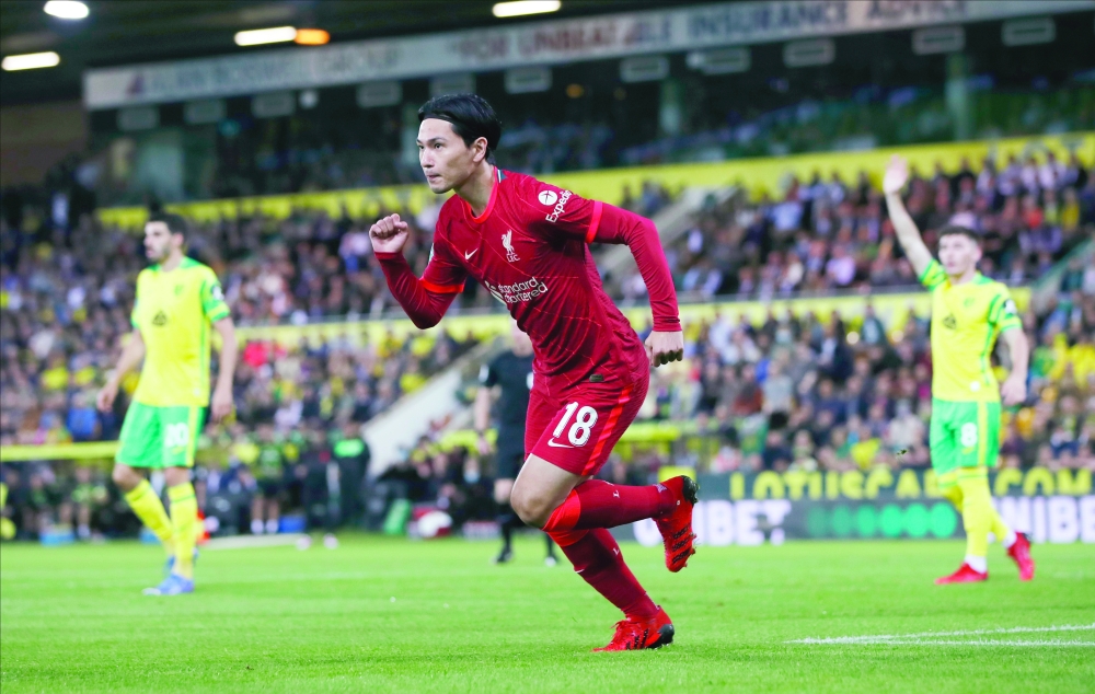 Liverpool's Takumi Minamino celebrates scoring their first goal against Norwich City. -- Reuters