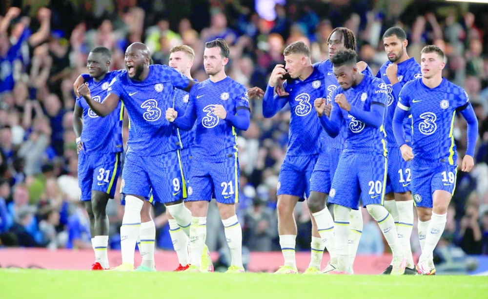 Chelsea players celebrate during the penalty shoot-out against Aston Villa. -- Reuters 