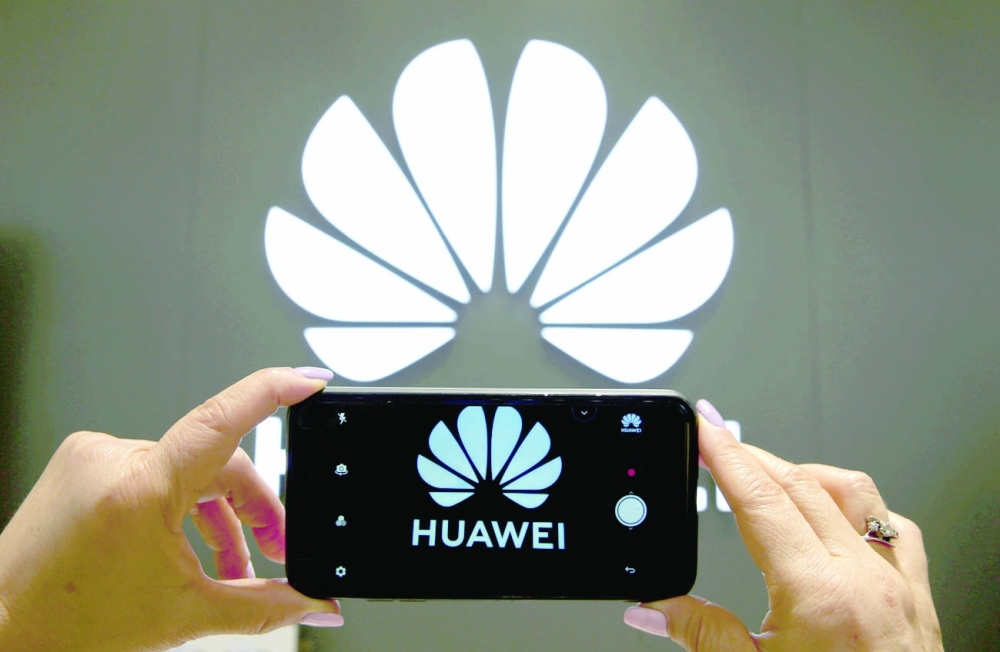 FILE PHOTO: A Huawei logo is seen on a cell phone screen in their store at Vina del Mar