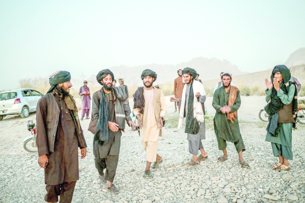 Taliban members enjoy a traditional dance on the banks of a river in Kandahar. -- AFP
