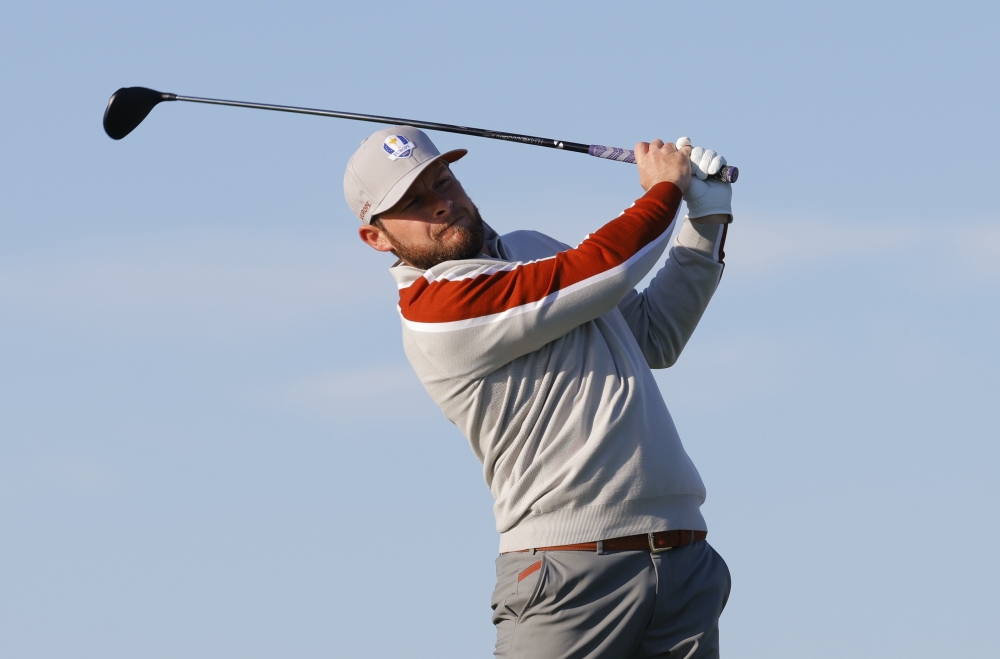 Team Europe's Tyrrell Hatton hits his tee shot on the 6th hole during the Foursomes. -- Reuters