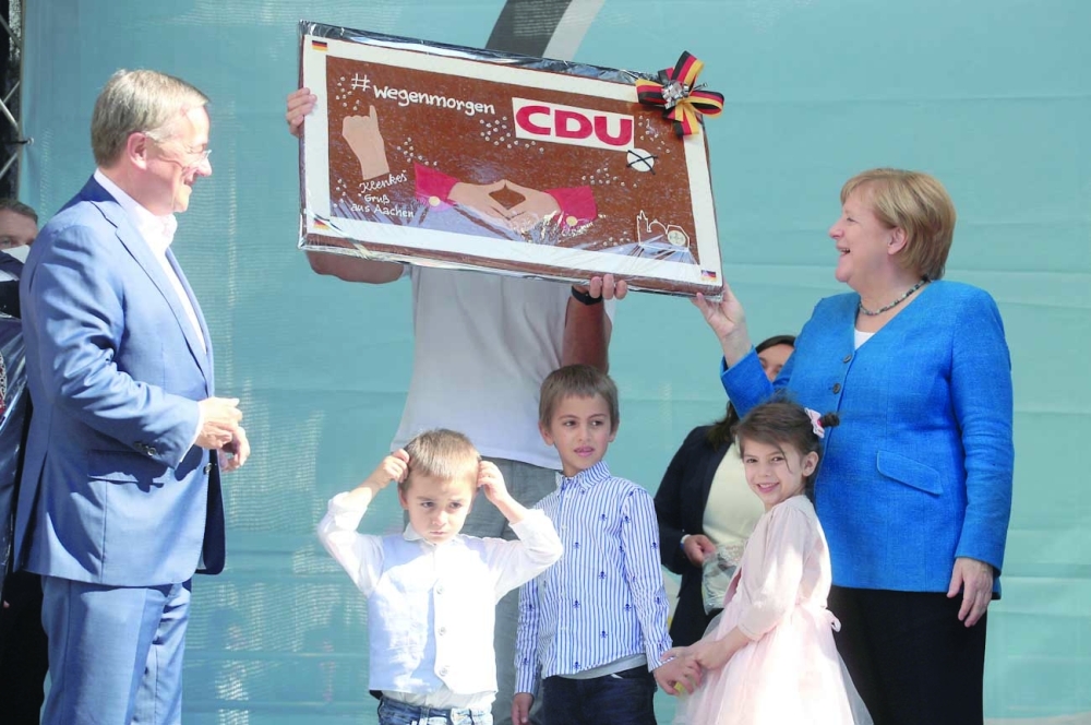 German Chancellor Angela Merkel and Armin Laschet attend a rally in Aachen. -- Reuters