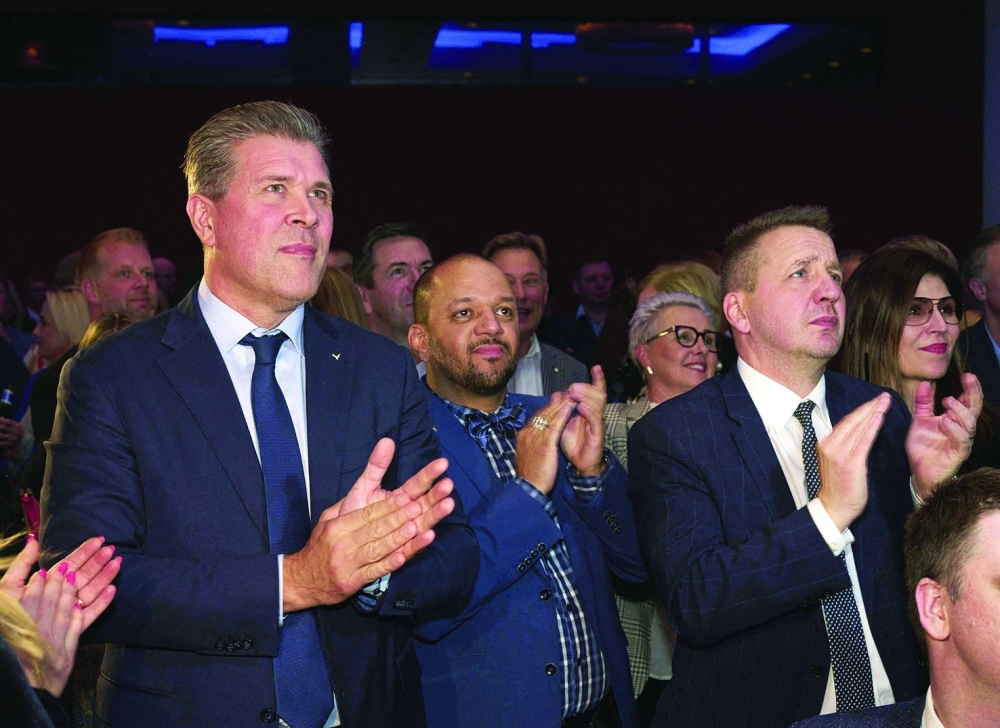 Iceland's Finance Minister, leader and top candidate of the Icelandic Independence Party Bjarni Benediktsson (L) and party delegates react to the results in Reykjavik. - AFP