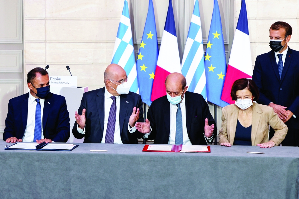 Greek Prime Minister Kyriakos Mitsotakis, Greek Defence Minister Nikolaos Panagiotopoulos, Greek Foreign Affairs Minister Nikos Dendias, French Foreign Affairs Minister Jean-Yves Le Drian, French Defence Minister Florence Parly and French President Emmanuel Macron take part in the signing ceremony of a new defence deal in Paris. - Reuters