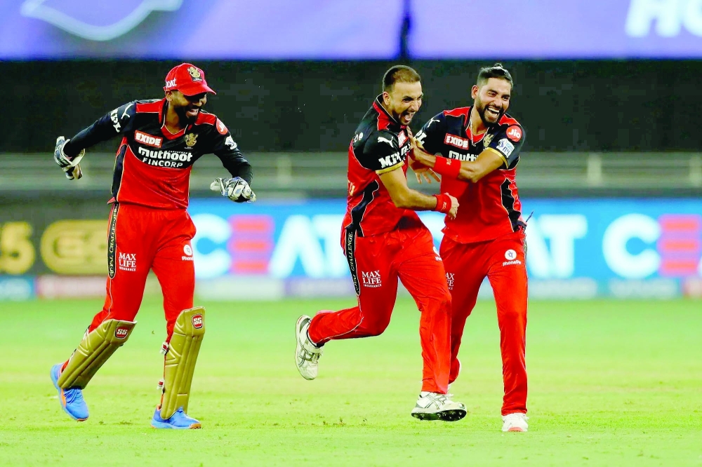 RCB's Harshal Patel celebrates his hat-trick wicket against Mumbai Indians. - BCCI