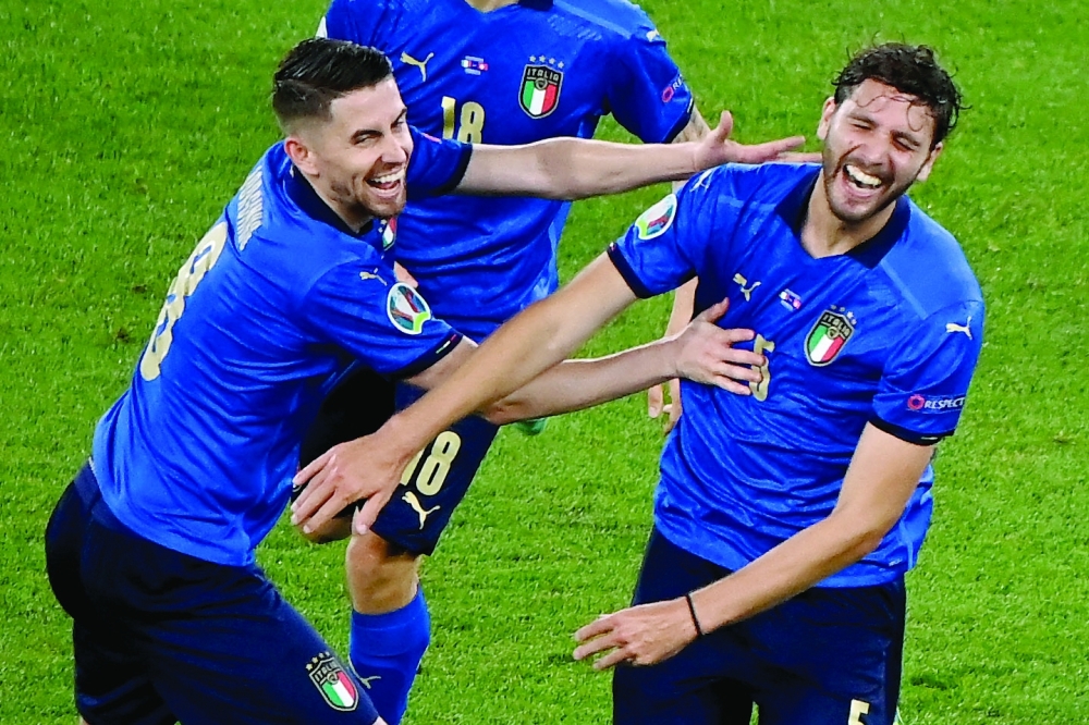 (FILES) In this file photo taken on June 16, 2021, Italy's midfielder Manuel Locatelli (R) celebrates with Italy's midfielder Jorginho after he scored the team's second goal during the UEFA EURO 2020 Group A football match between Italy and Switzerland at the Olympic Stadium in Rome. During the Euro of Italy, Manuel Locatelli quickly grew up with the "professor" Jorginho. The Juventus midfielder will compete against the Chelsea strategist on September 29, 2021, in the Champions League. (Photo by Riccardo Antimiani / AFP)

