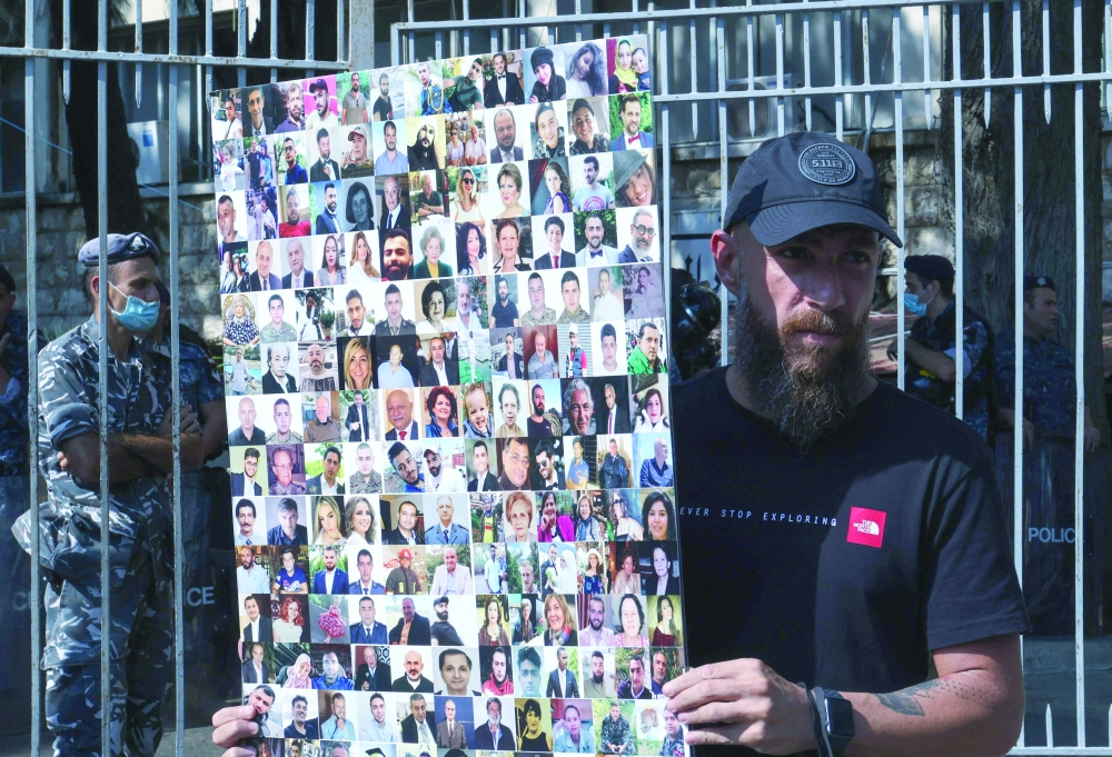 Activists and relatives of victims of the Beirut port explosion demonstrate outside the capital's Justice Palace on Wednesday. - AFP