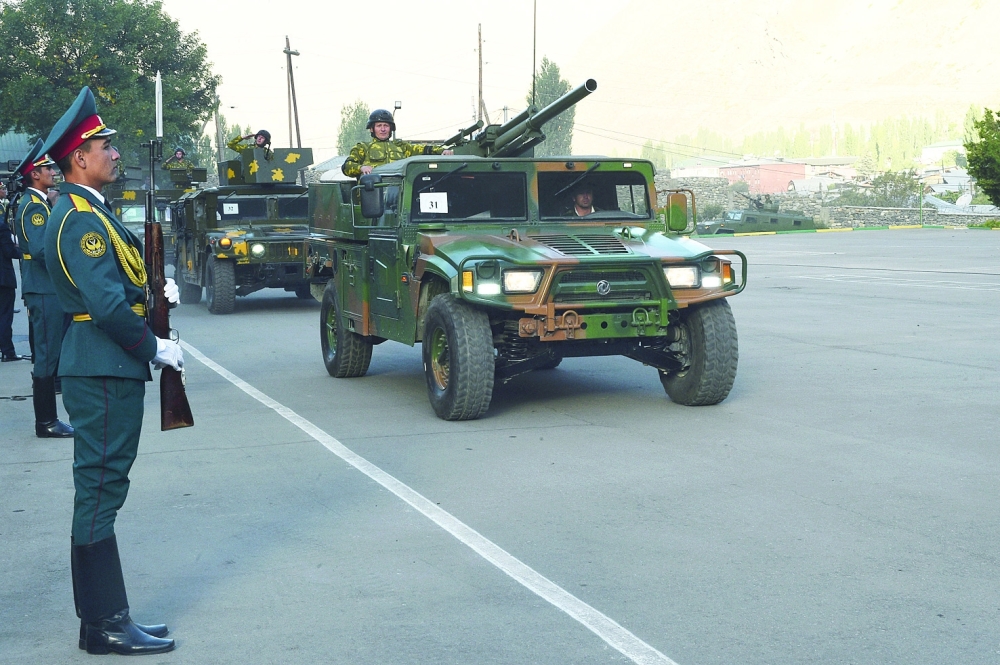 Tajik service members take part in a military parade near the border with Afghanistan in the town of Khorugh. -- Reuters
