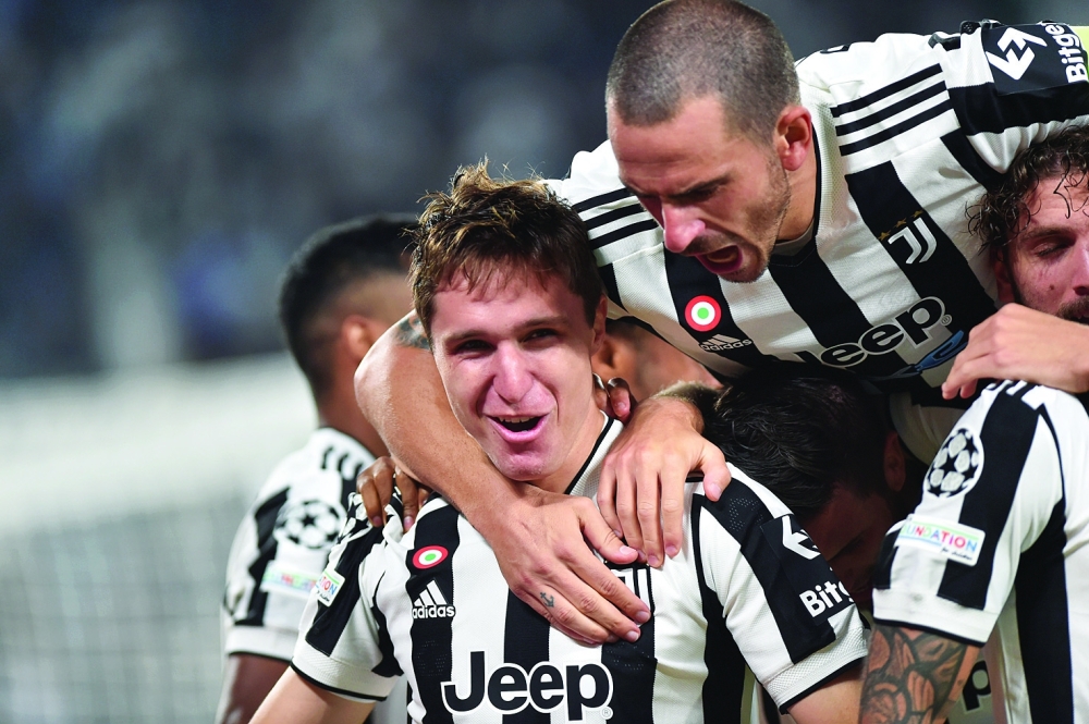 Juventus' Federico Chiesa celebrates scoring their first goal with Leonardo Bonucci. -- Reuters