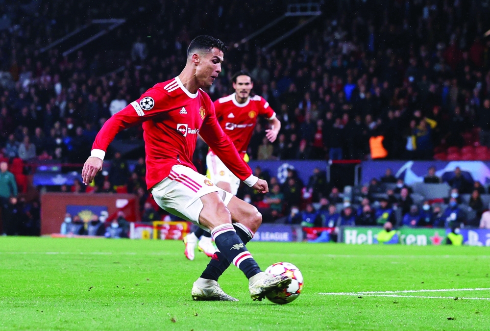 Manchester United's Cristiano Ronaldo scores their second goal. -- Reuters