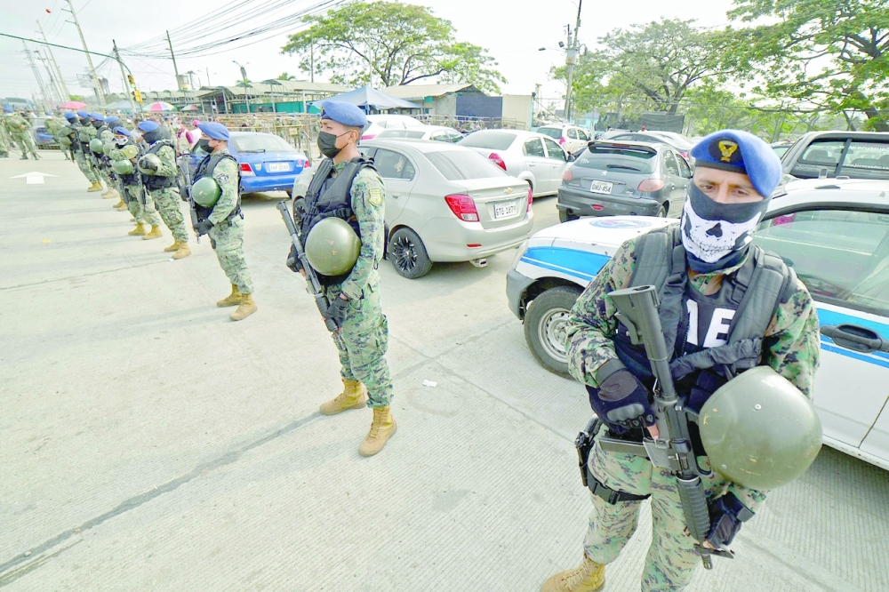 Soldiers stand guard outside the Guayas 1 prison in Guayaquil. -- AFP