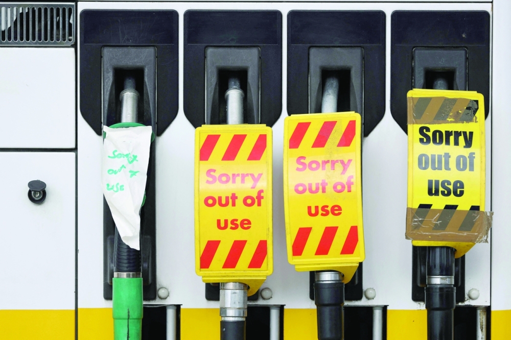 'Out of Use' signage is pictured on the petrol pumps  of a closed fuel filling station in Hook, Hampshire on Thursday. -- AFP