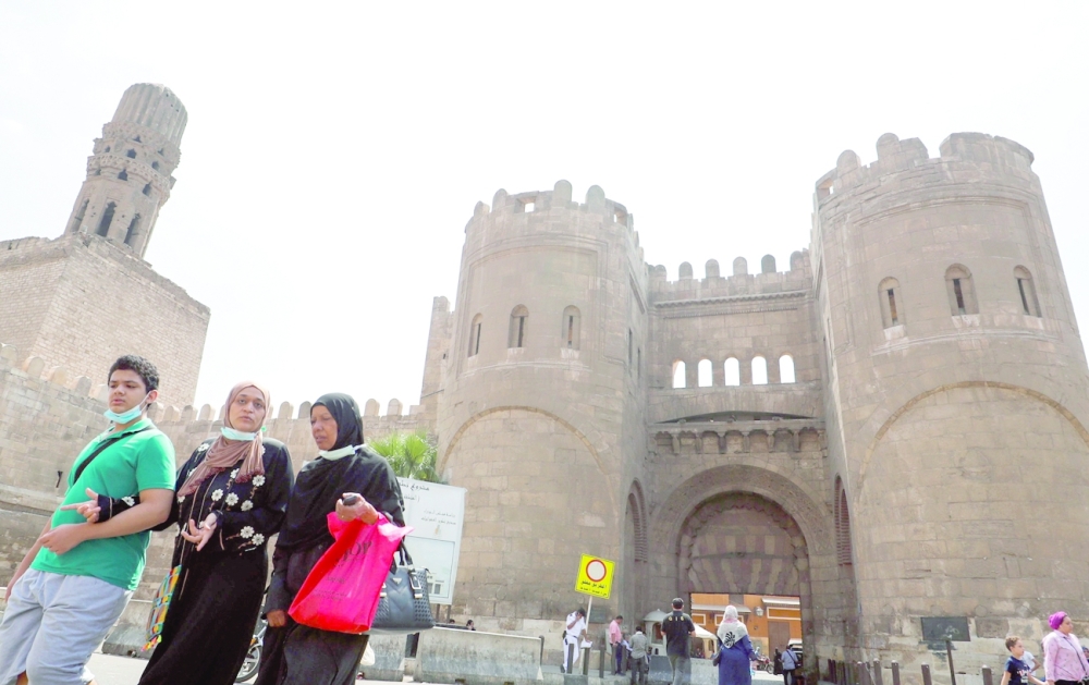 People walk next to Bab al-Futuh, a nearly 1,000-year-old gate, at the northern entrance to the historic city of Cairo. -- Reuters