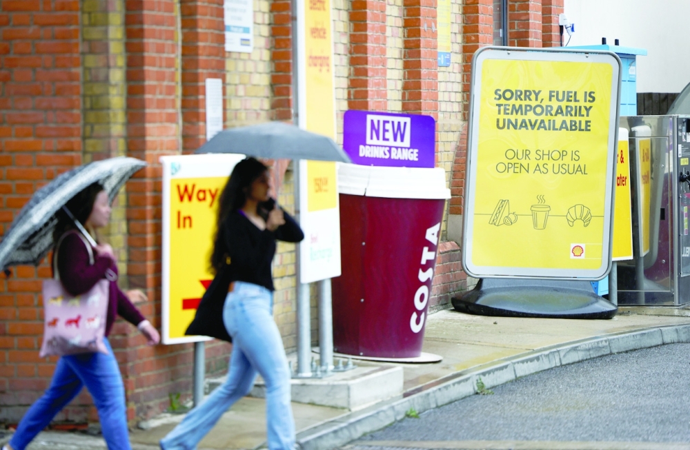 A sign informing customers that fuel has run out is pictured at a fuel station in London. -- Reuters