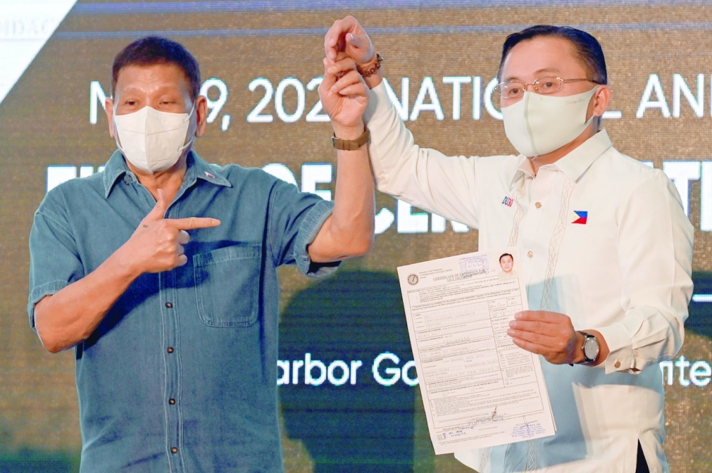 Philippine Senator Christopher 'Bong' Go, accompanied by Philippine President Rodrigo Duterte, files his certificate of candidacy to join the vice presidential race, at Sofitel Harbor Garden Tent, in Pasay City, Metro Manila. -- Reuters