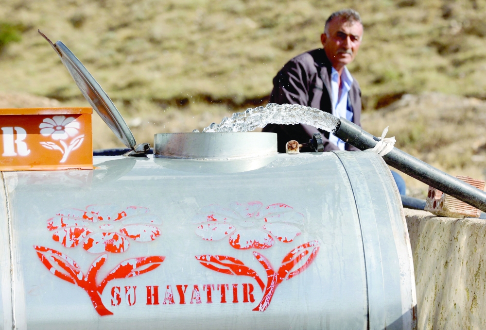 A farmer waits for his tank to be filled with water in Cubuk district, northern Ankara. - AFP