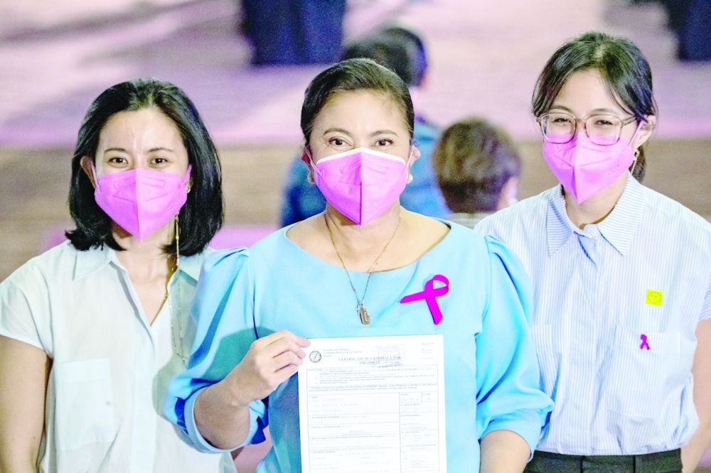Philippine Vice President Leni Robredo poses with her daughters Aika and Tricia after filing her certificate of candidacy for president in the 2022 national election. -- Reuters