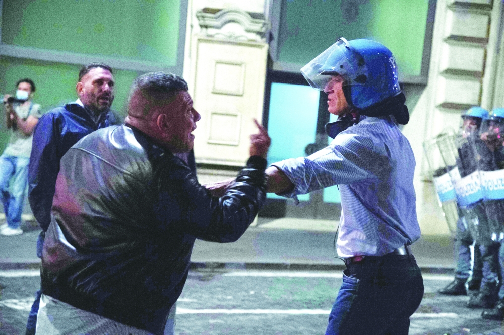 A protester during clashes with riot policeman following a protest against the mandatory sanitary pass called 'green pass' in the aim to limit the spread of the Covid-19 in central Rome. - AFP
