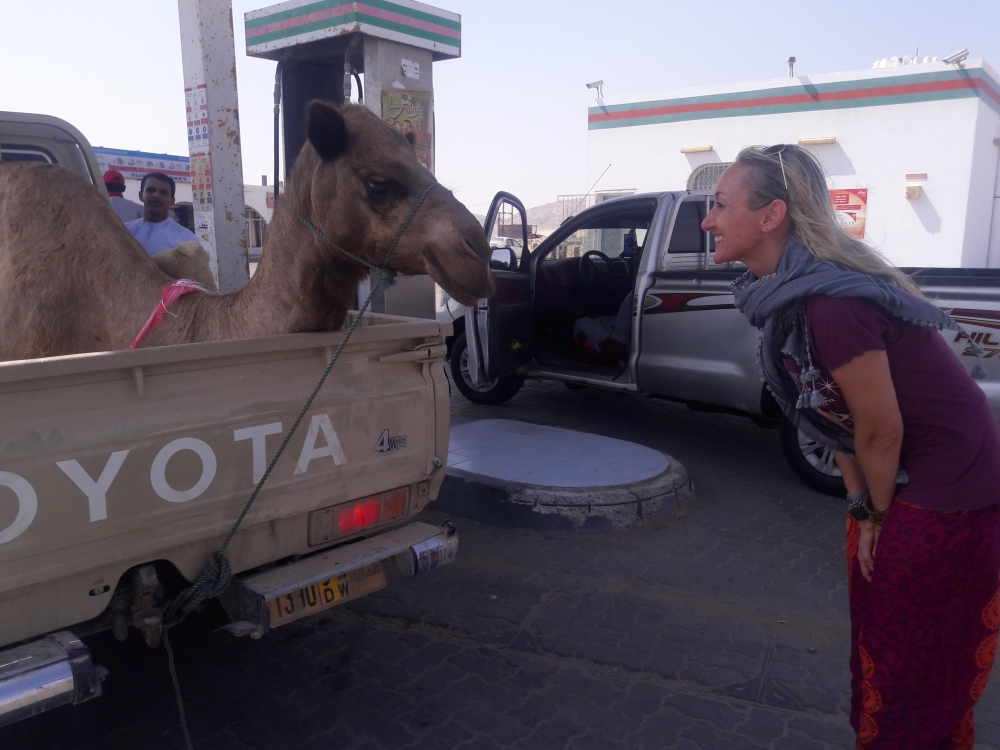 Elizabeth Sunday plays with a camel