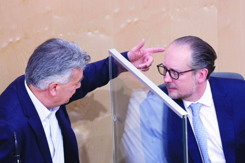 Austria's Chancellor Alexander Schallenberg and Vice Chancellor Werner Kogler talk during a session of the parliament in Vienna. - Reuters