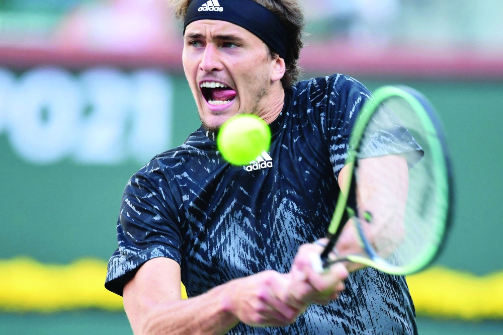 Alexander Zverev of Germany hits a backhand return against Andy Murray of Great Britain during their Round of 16 match at ATP-WTA Indian Wells tennis tournament on October 12, 2021 in Indian Wells, California (Photo by Frederic J. BROWN / AFP)

