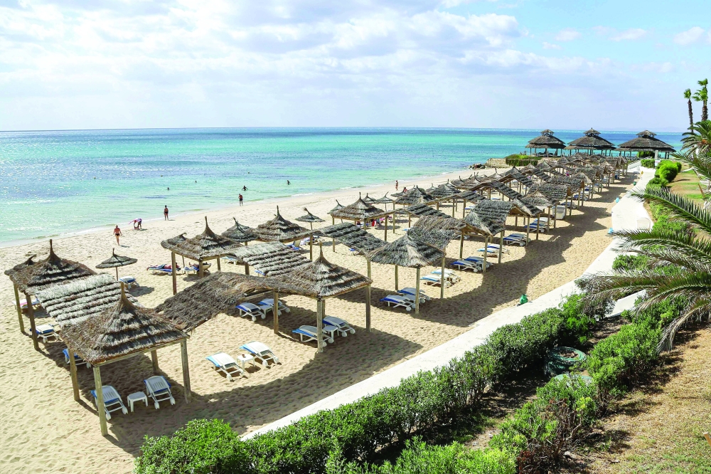 This picture shows a view of empty sunbeds and shades along a beach in Tunisia's resort town of Hammamet, about 66 km south of the capital Tunis. - AFP