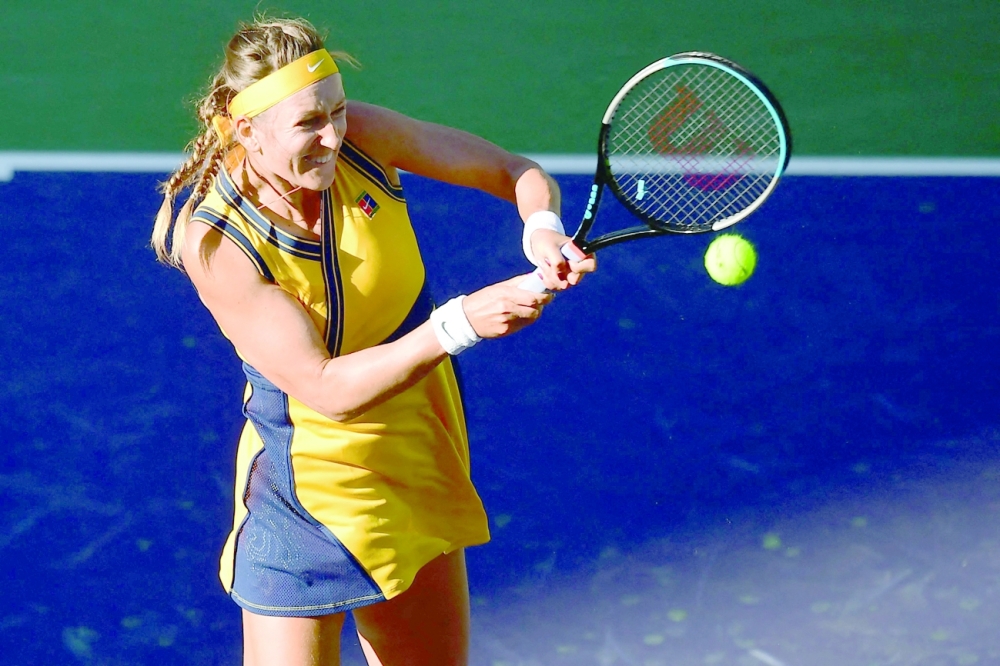 Victoria Azarenka of Belarus hits a backhand return to Jessica Pegula of the US during their quarterfinal match at the ATP-WTA Indian Wells tennis tournament on October 13, 2021 in Indian Wells, California. (Photo by Frederic J. BROWN / AFP)

