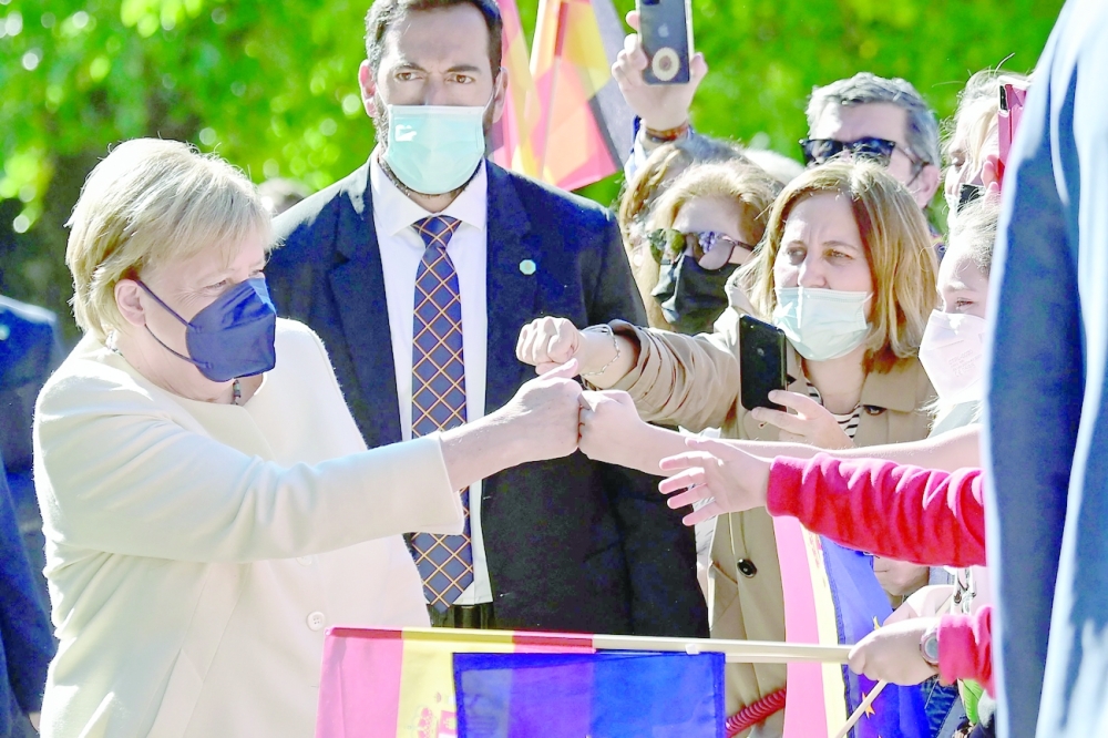 Germany's Chancellor Angela Merkel greets people as she arrives for the Carlos V European Award ceremony at the Royal Monastery of Yuste, in Cuacos de Yuste. -- AFP
