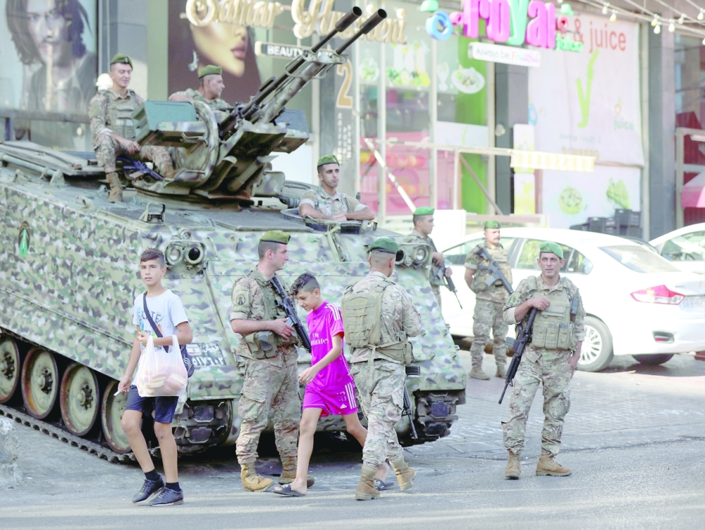 Soldiers patrol the streets a day after deadly shooting in Beirut. -- Reuters