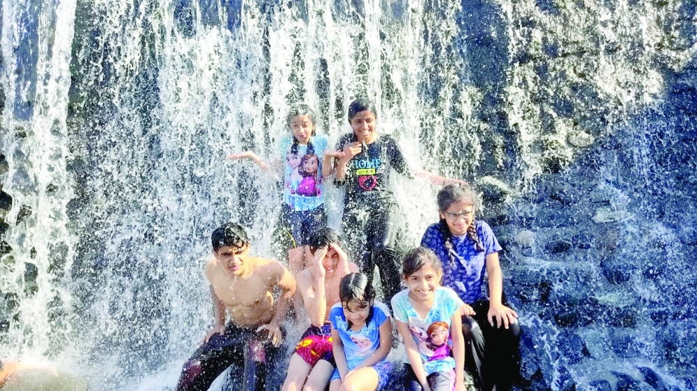 Children enjoy the waterfalls at Wadi Wadi Hoqain on Friday. Photo by KABEER YOUSUF 