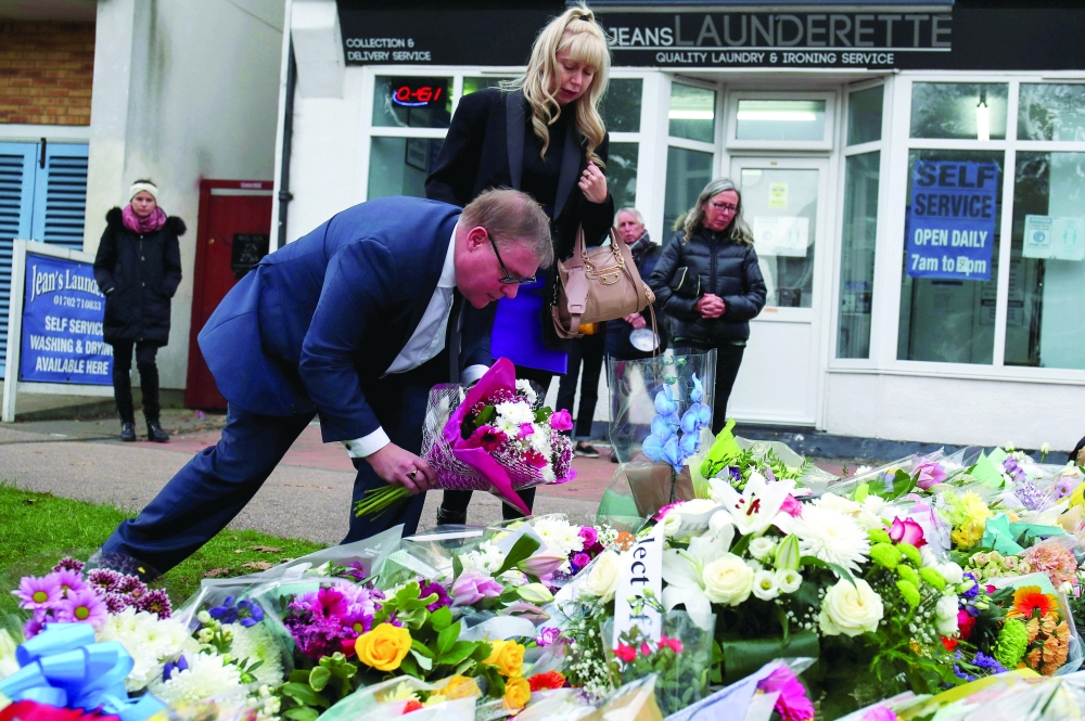 British MP Mark Francois lays flowers at the scene where MP David Amess was stabbed to death during a meeting with constituents at Belfairs Methodist Church, in Leigh-on-Sea. - Reuters
