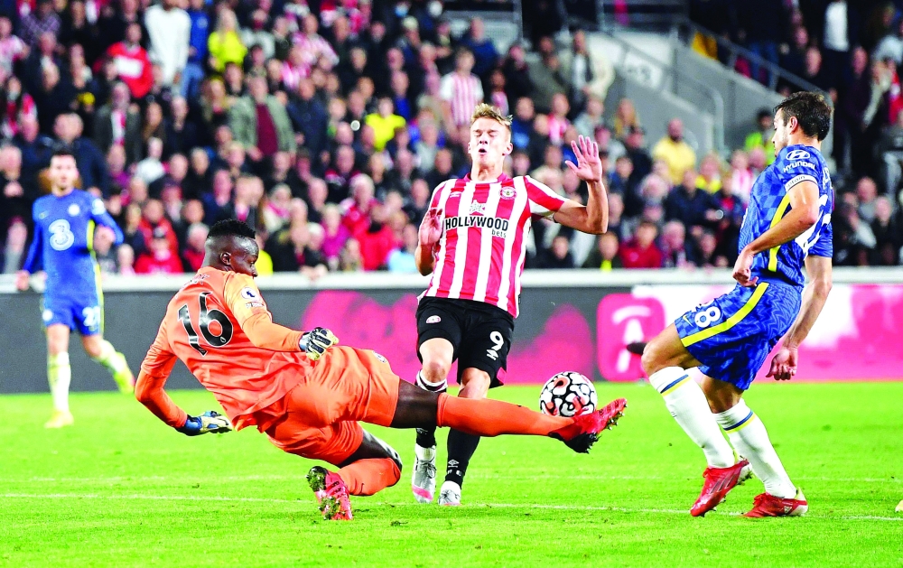 Chelsea's Edouard Mendy in action with Brentford's Marcus Forss. --  Reuters