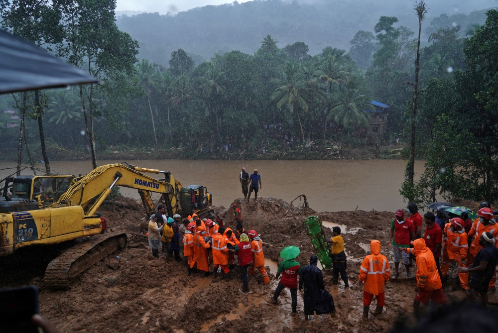Rescue workers carry the body of a victim after recovering it from the debris of a residential house following a landslide caused by heavy rainfall at Kokkayar village in Idukki district in the southern state of Kerala, India. 