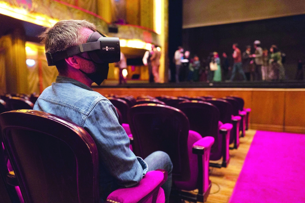 A spectator wearing 'virtual reality' headsets attend a rehearsal of the world first 'Toulouse-Lautrec' new ballet, at the Capitol Theatre of Toulouse, southern France. With this season opening show at the 'Thaatre du Capitole' in Toulouse, from October 16 to 23, the former star dancer of the Paris Opera innovates with cutting-edge technology 'which will allow the spectator to project themselves on stage' in wearing a helmet. - AFP
