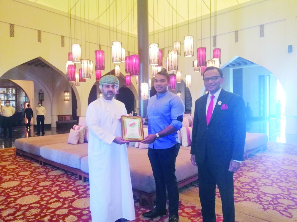 Dr Marwan al Juma handing over a memento to Namal Rajapaksa, the visiting Sri Lankan minister of sports as OL Ameer Ajwad, Sri Lankan Ambassador to the Sultanate looks on. 
