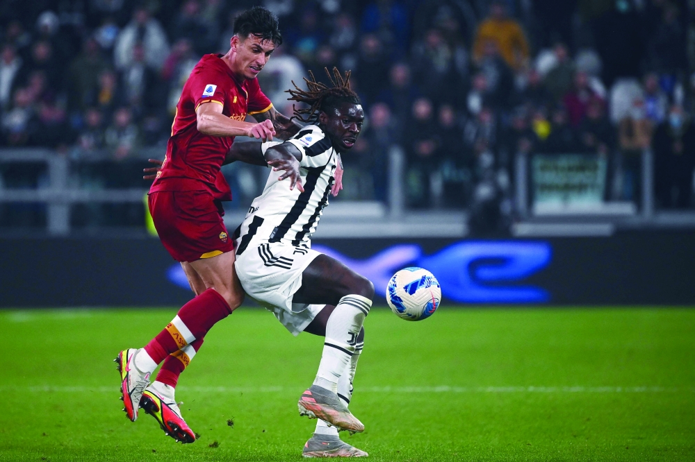Roma's defender Roger Ibanez (L) and Juventus' Moise Kean go for the ball during the Serie A match at the Juventus stadium in Turin. -- AFP

