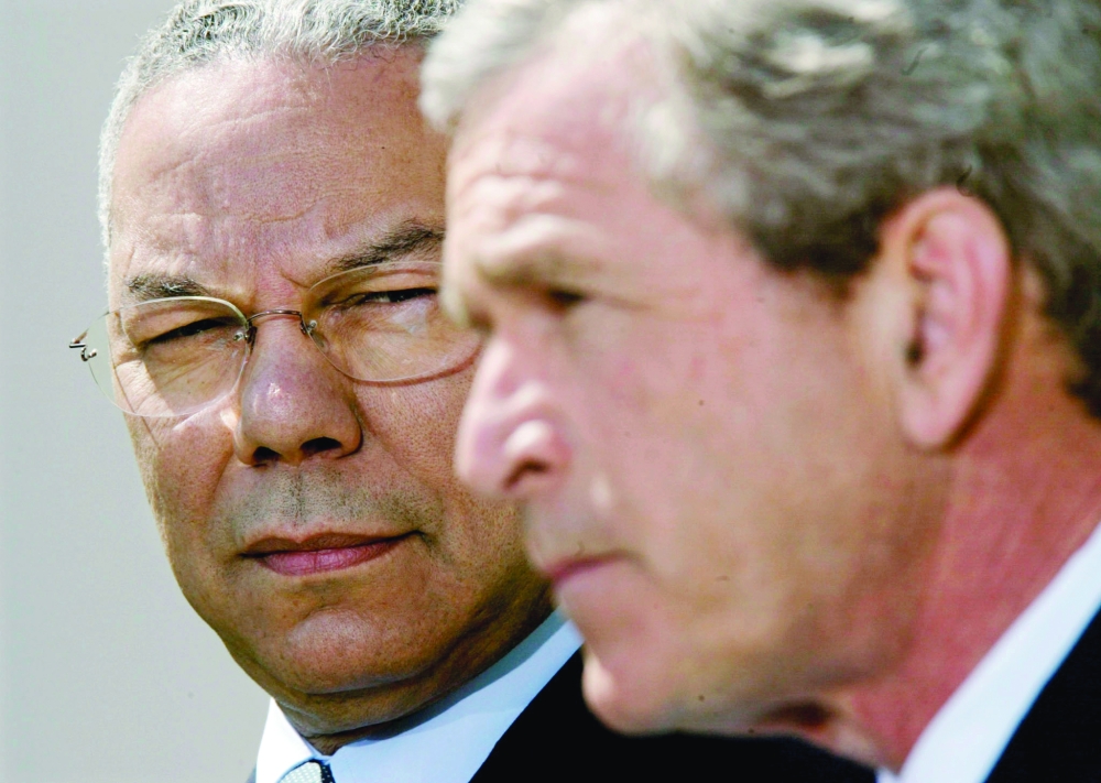 Former US president George W Bush with Colin Powell.