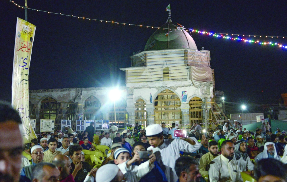 Iraqis gather to celebrate Mawlid al-Nabawi in the courtyard of the war-ravaged landmark Al Nouri mosque, in Mosul, on Sunday night. - AFP
