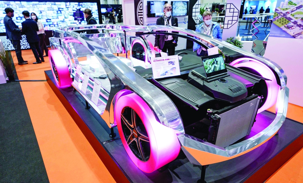 A car model at a stall of LG Electronics and displaying vehicle technology such as Soft V2X (Vehicle-to-smartphone) at the ITS World Congress on Intelligent Transport Systems and Services held at the CCH Congress Center in Hamburg, northern Germany. The congress concluded last week. - AFP