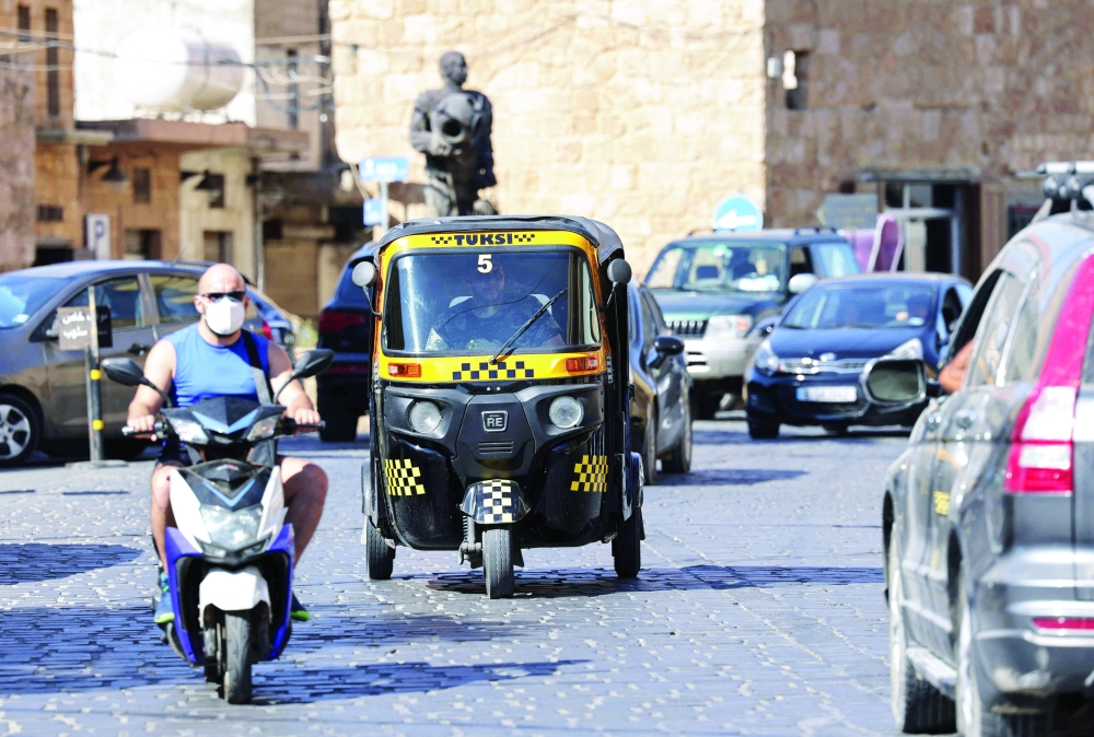 A tuktuk taxi drives on a street in the Lebanese city of Batroun north of the capital. - AFP