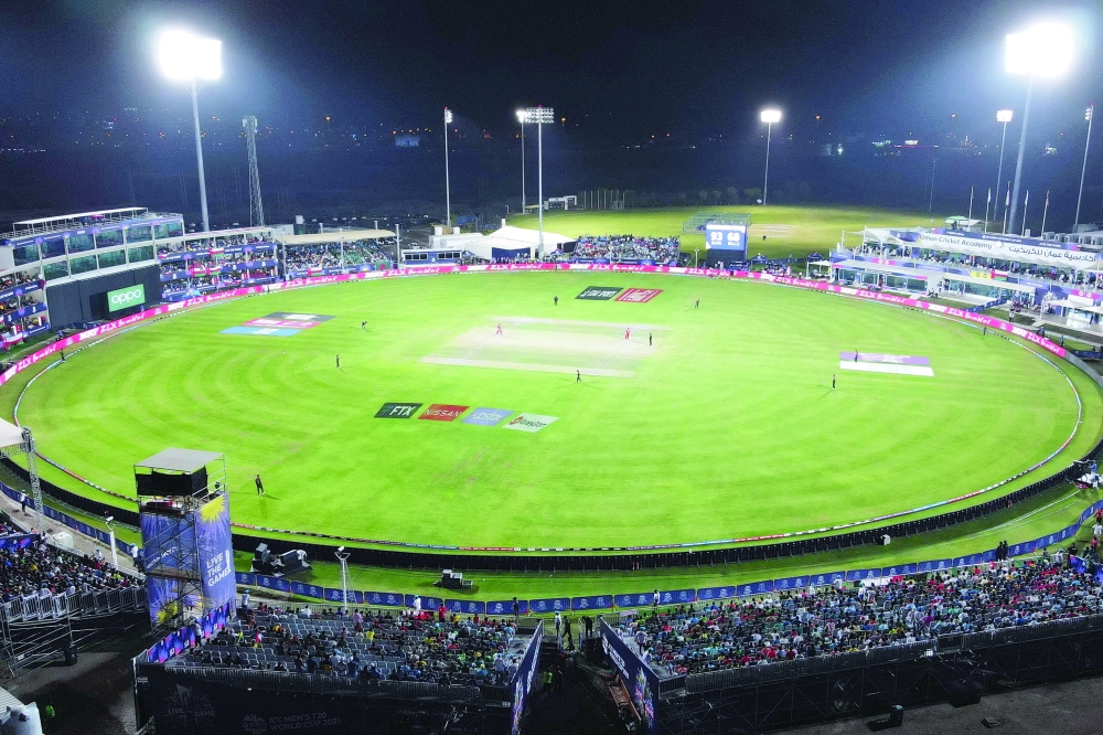 This areal view shows cricketers playing during the ICC men's Twenty20 World Cup cricket match between Oman and Bangladesh at the Oman Cricket Academy Ground in Muscat on October 19, 2021. (Photo by Haitham AL-SHUKAIRI / AFP)