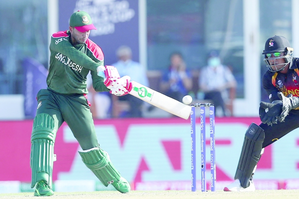Bangladesh's Shakib Al Hasan plays a shot during the ICC men's Twenty20 World Cup cricket match between Bangladesh and Papua New Guinea at the Oman Cricket Academy Ground in Muscat on October 21, 2021. (Photo by Haitham AL-SHUKAIRI / AFP)

