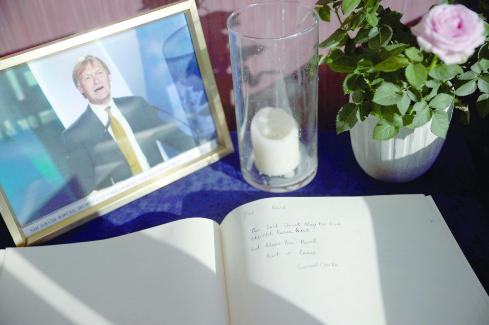 A tribute is written for David Amess in a book of condolence at the Iveagh Conservative Club in Leigh-on-Sea, Britain, on Thursday. - Reuters