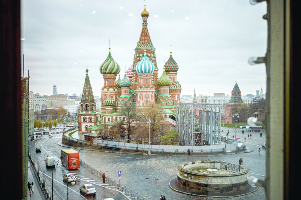 People walk through Red Square with Saint Basil's Cathedral on the background in Moscow on Thursday. - AFP