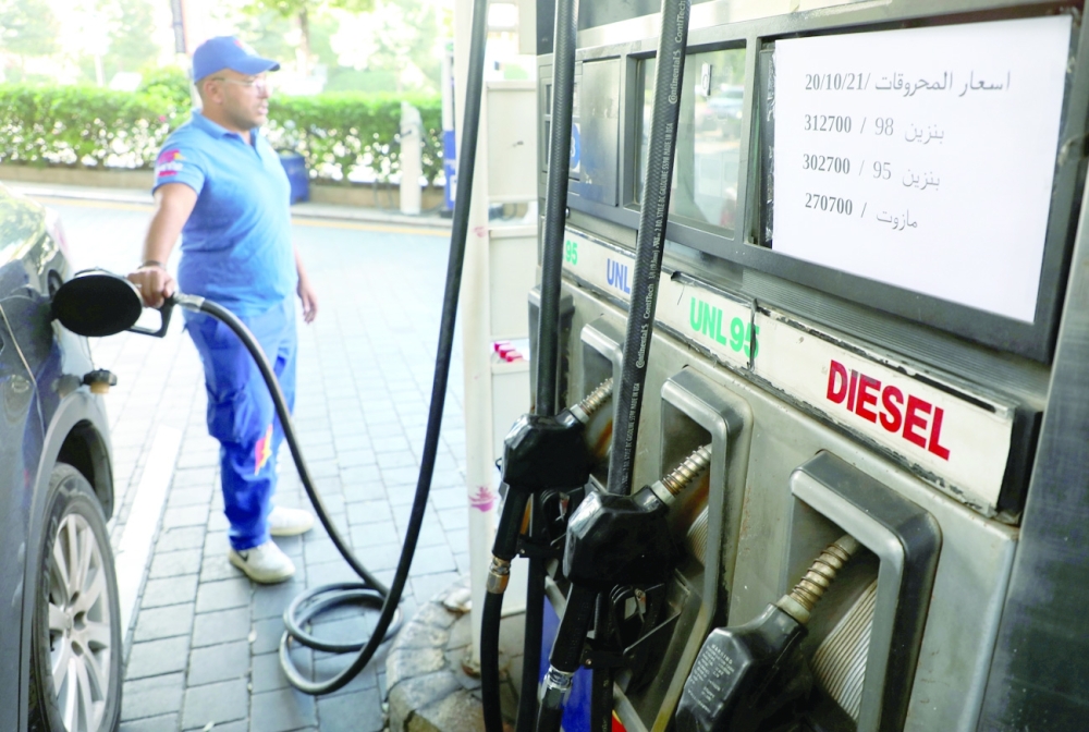A worker fills up a car with fuel at a gas station in Beirut on Friday. - Reuters