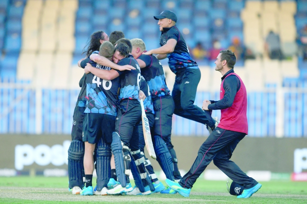 Namibia's cricketers celebrate their victory at the end of the ICC T20 World Cup match against Ireland at the Sharjah Cricket Stadium in Sharjah. -- AFP