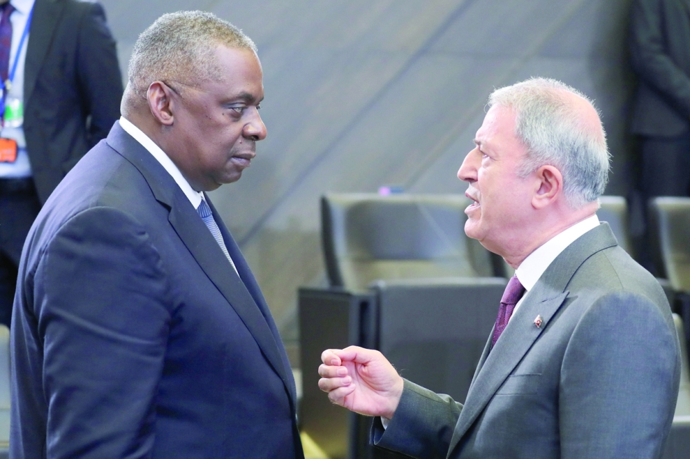 US Defence Secretary Lloyd Austin talks with Turkey's Defence Minister Hulusi Akar as they attend a Nato Defence Ministers meeting in Brussels, Belgium. - Reuters 